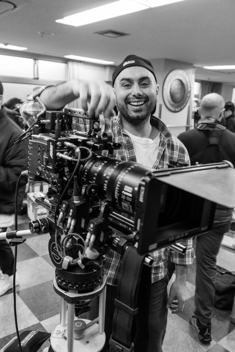 Sina Engin operating a cinema camera on set